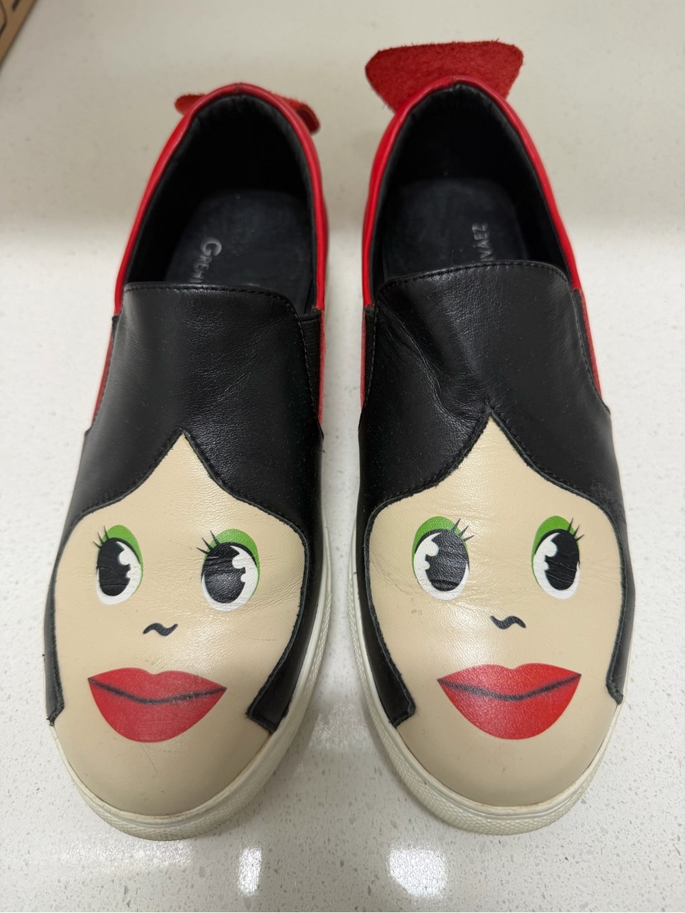 Women’s Novelty Slip-On Sneakers - Black, Red, Cream Face Graphic